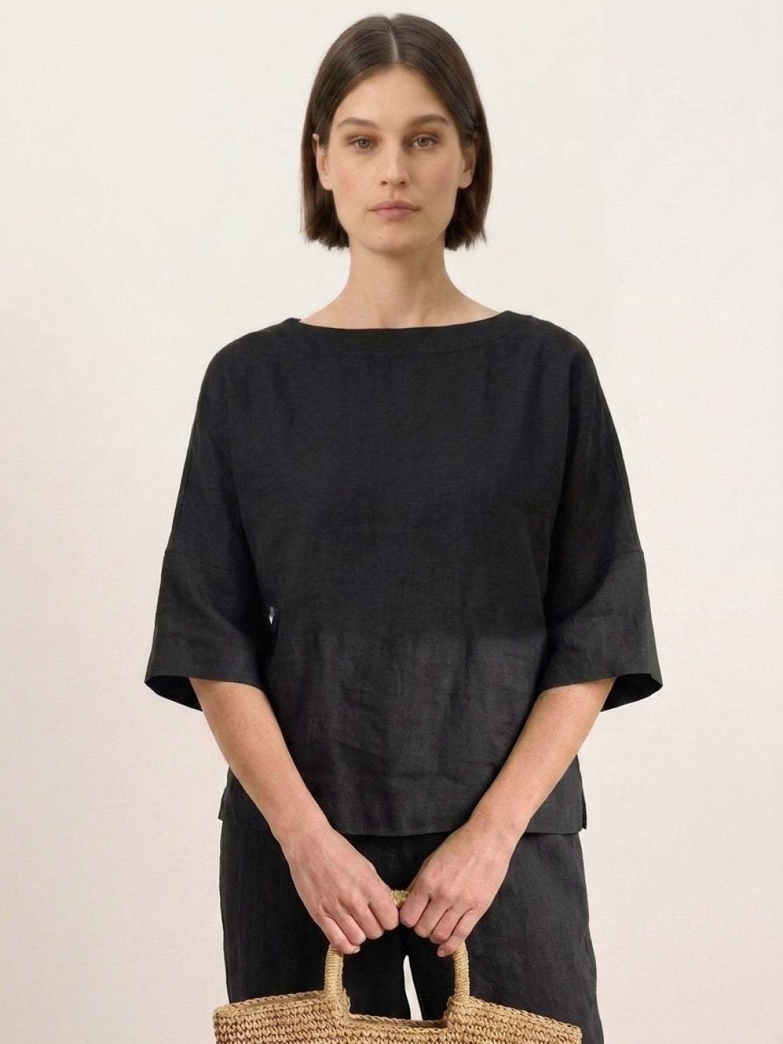 Woman wearing black Batwing Leisure Co-Ord with boxy crop top and high-waisted tapered pants