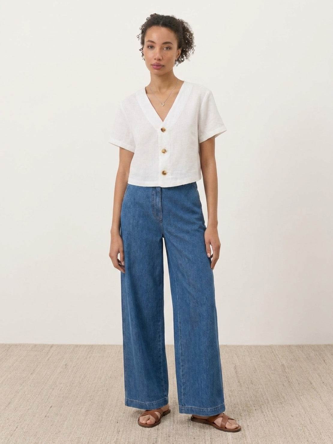 Lightweight 100% linen French top with relaxed boxy shape and three-button V-neck detail in light khaki