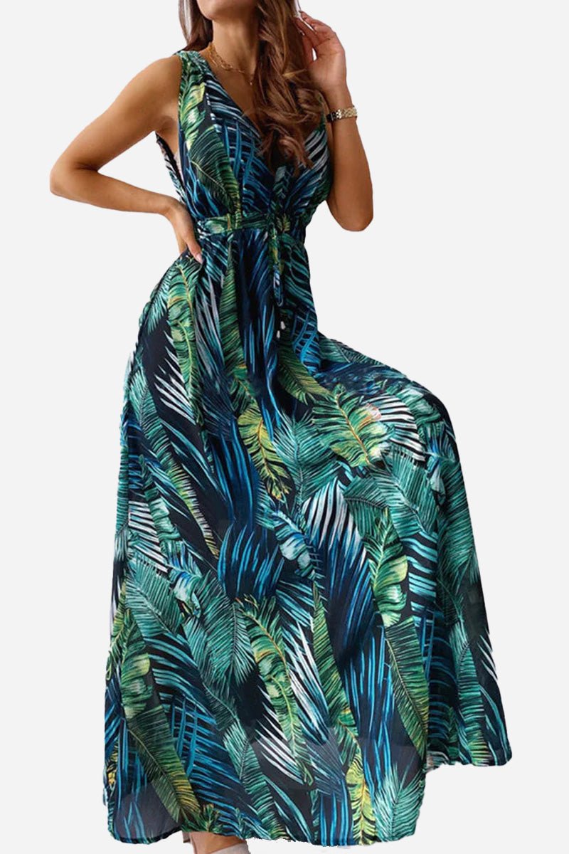 Woman wearing a casual sleeveless dress with green and blue tropical leaf print