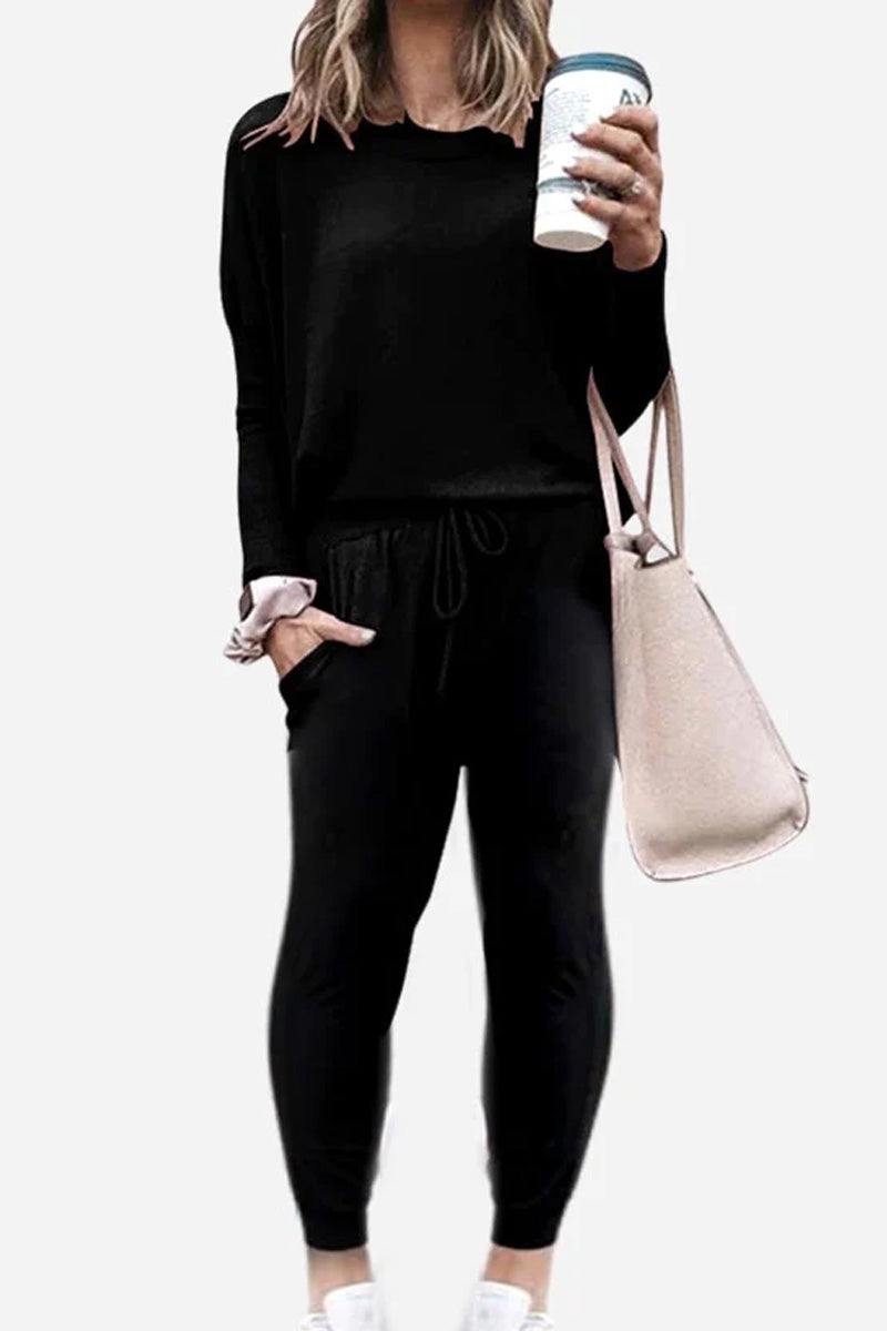 woman wearing Cozy Chic Two-Piece Sweatsuit Set with long-sleeve top and high-waisted pants with pockets