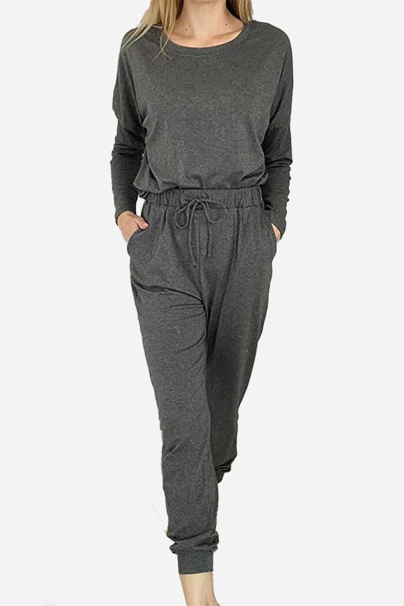 Woman modeling cozy chic two-piece sweatsuit set with long-sleeve top and high-waisted pants with pockets