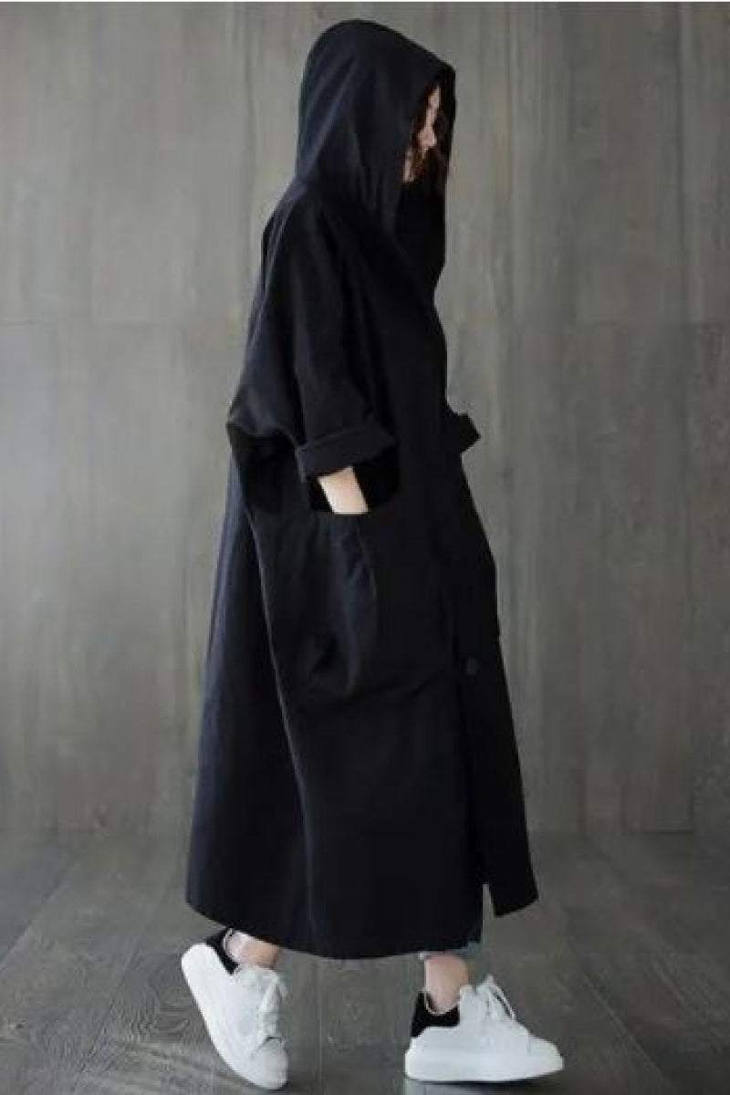 Black oversized water resistant windbreaker jacket with hood and pockets, styled for Halloween collection