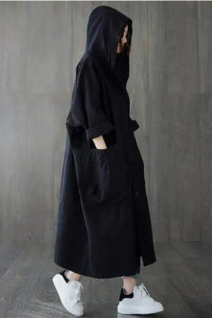 Black oversized water resistant windbreaker jacket with hood and pockets, styled for Halloween collection