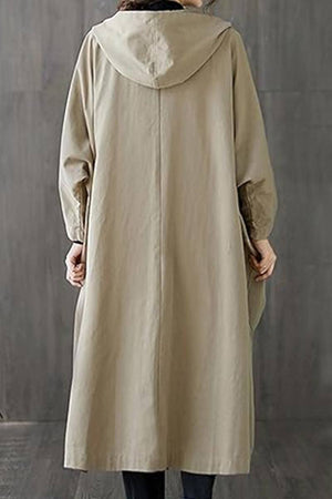 Back view of oversized beige water resistant windbreaker jacket with hood and long sleeves