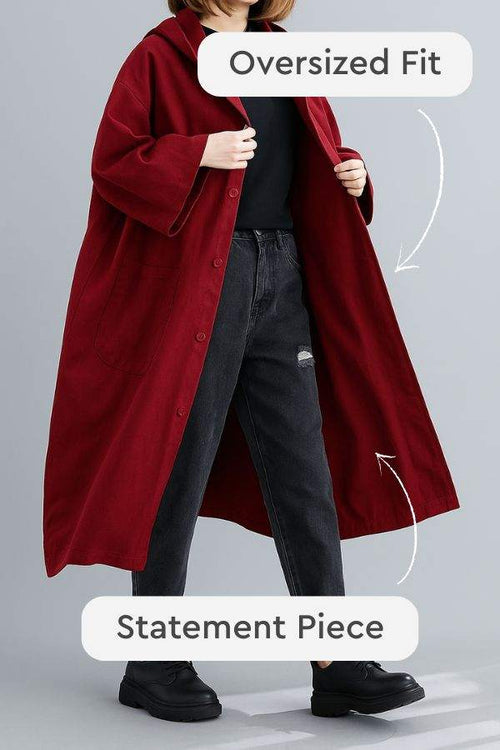 Red oversized water resistant windbreaker jacket with button closure and trendy loose fit, styled as a statement piece for layering.