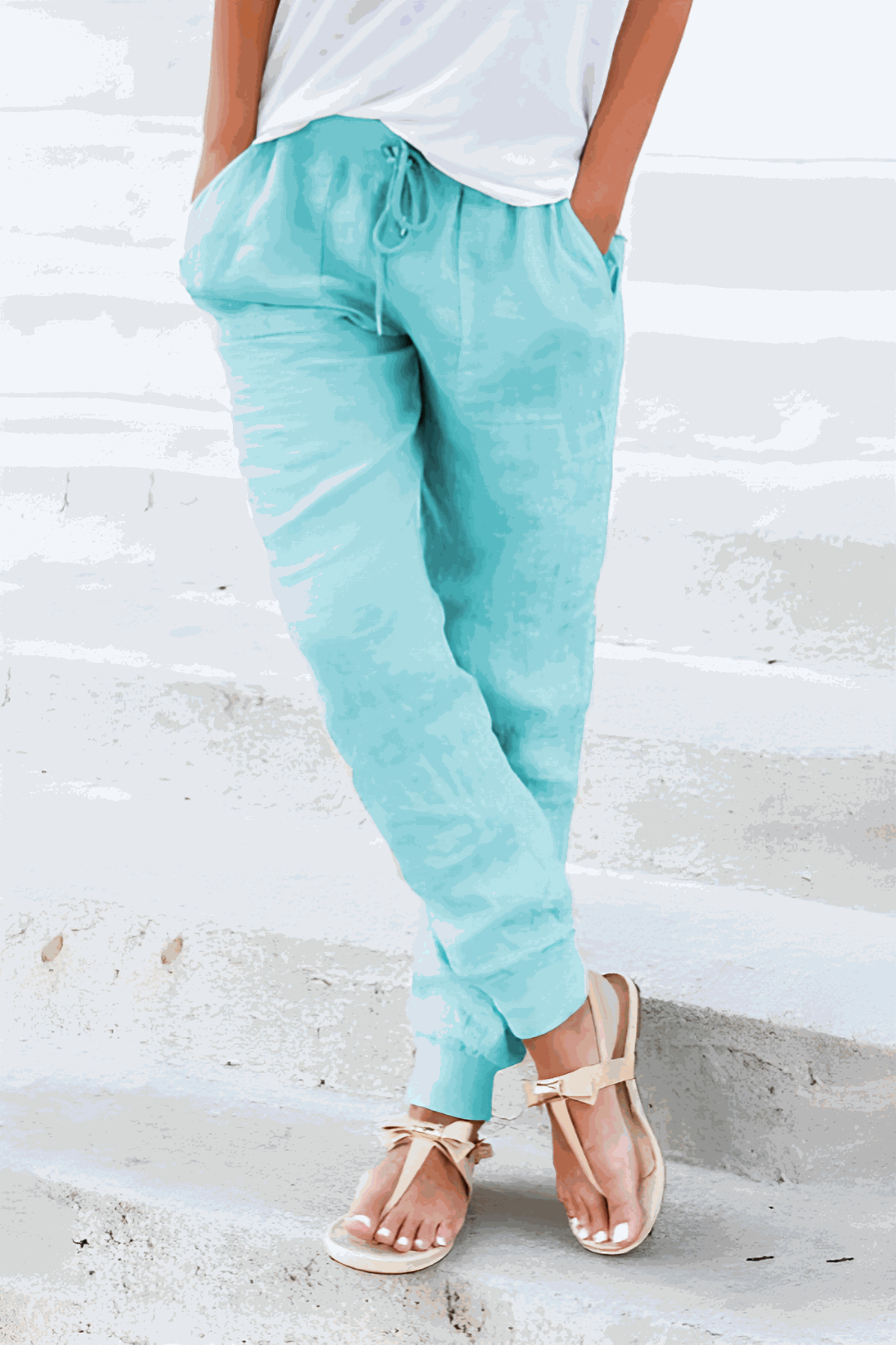 Woman wearing relaxed chic elastic ankles pants styled casually in neutral tones