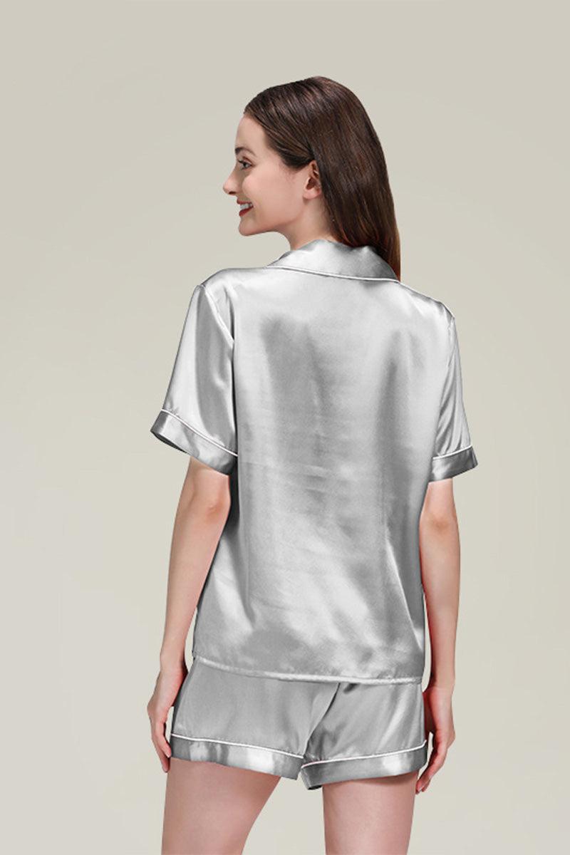 Back view of woman wearing silver Mulberry silk buttoned short set pajamas