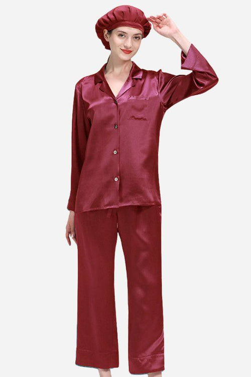 Woman wearing classic burgundy mulberry silk pajama set with matching sleep cap