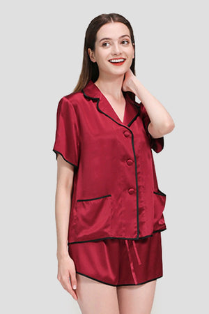 Woman wearing luxurious red mulberry silk Hemd trimmed short-sleeve pajama set with black hems
