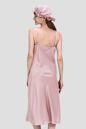 Back view of woman wearing pink mulberry silk elegant night dress and matching silk sleep cap