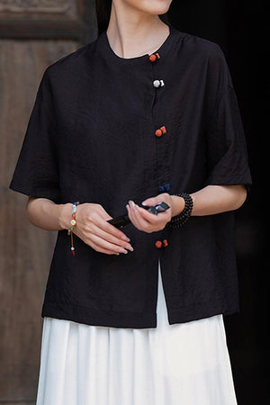 Black regenerated cellulose blouse with asymmetrical buttons and relaxed fit on model