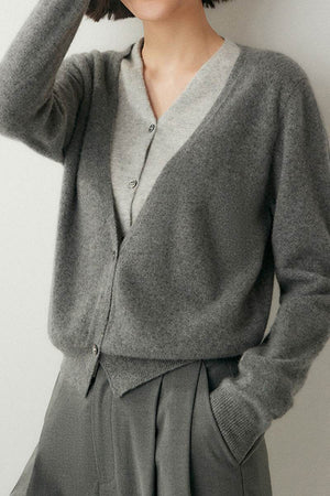 Single-breasted cashmere wool cardigan in soft gray, lightweight and warm for versatile layering and travel.