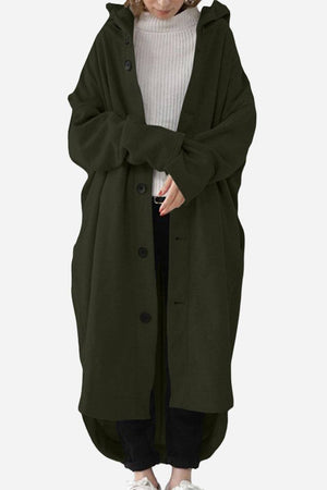 Woman wearing oversized everyday buttoned hooded coat in dark green over casual outfit