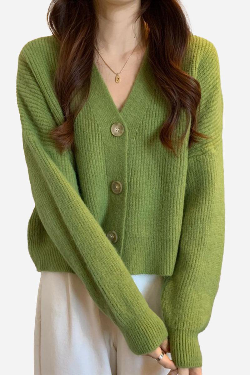 Green casual loose boxy cardigan with V-neck and buttons worn over white pants