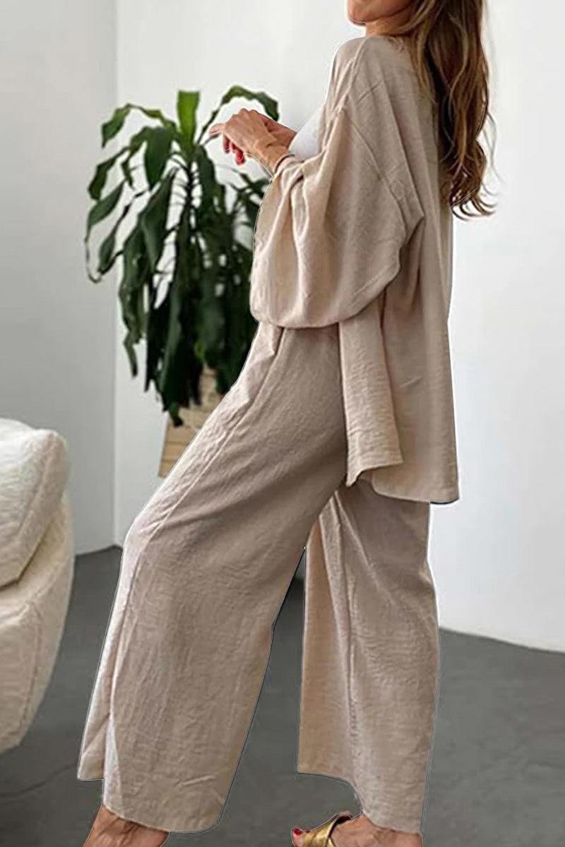 Woman wearing beige relaxed fit Vacation Essentials Cotton Set with wide-leg pants and oversized button-up top in casual indoor setting