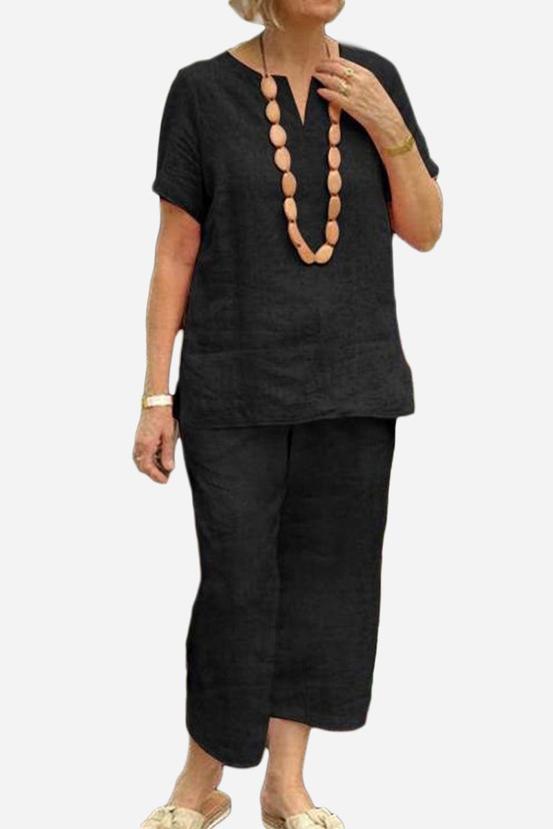 Woman wearing black breezy cotton blend two-piece set with short-sleeve top and elastic waist pants