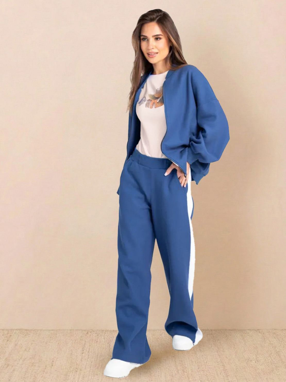 Two-piece easy airport lounge set in soft cotton-blend fabric, featuring a zip-front jacket and wide-leg pants for travel comfort and wrinkle resistance.