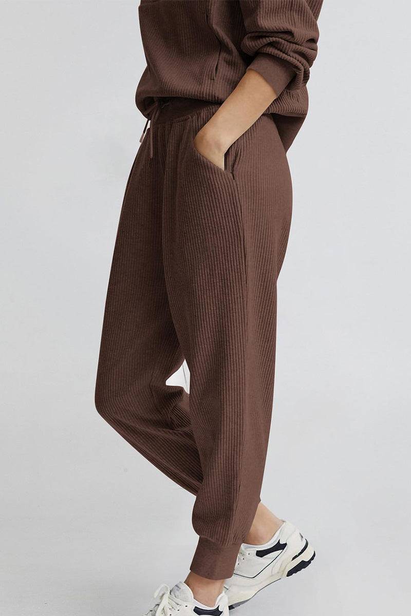 Unisex half-zip pullover and sweatpants set in brown with ribbed texture and relaxed fit