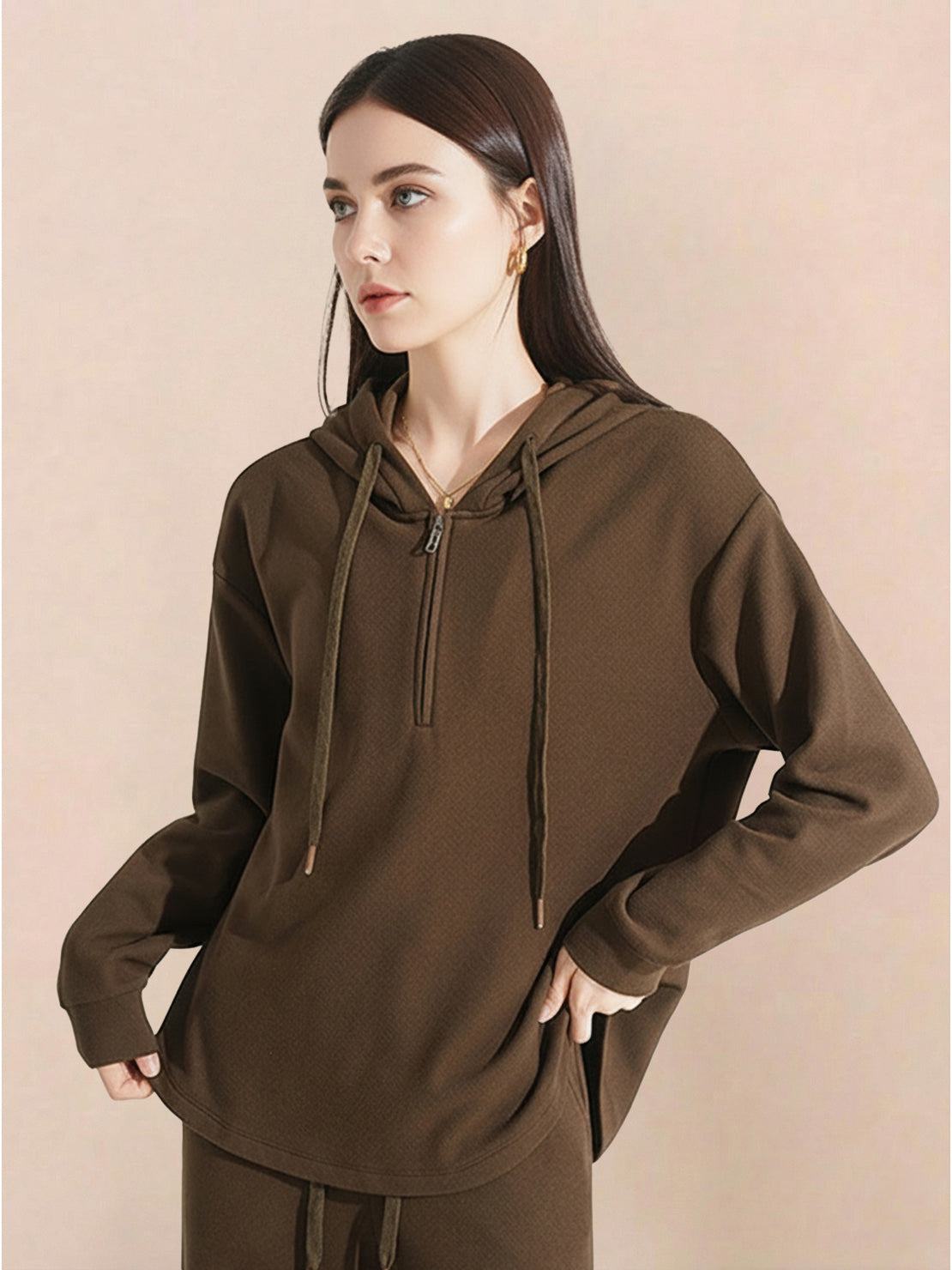 Woman wearing brown lyocell-blend hooded set with zip and drawstring hood.
