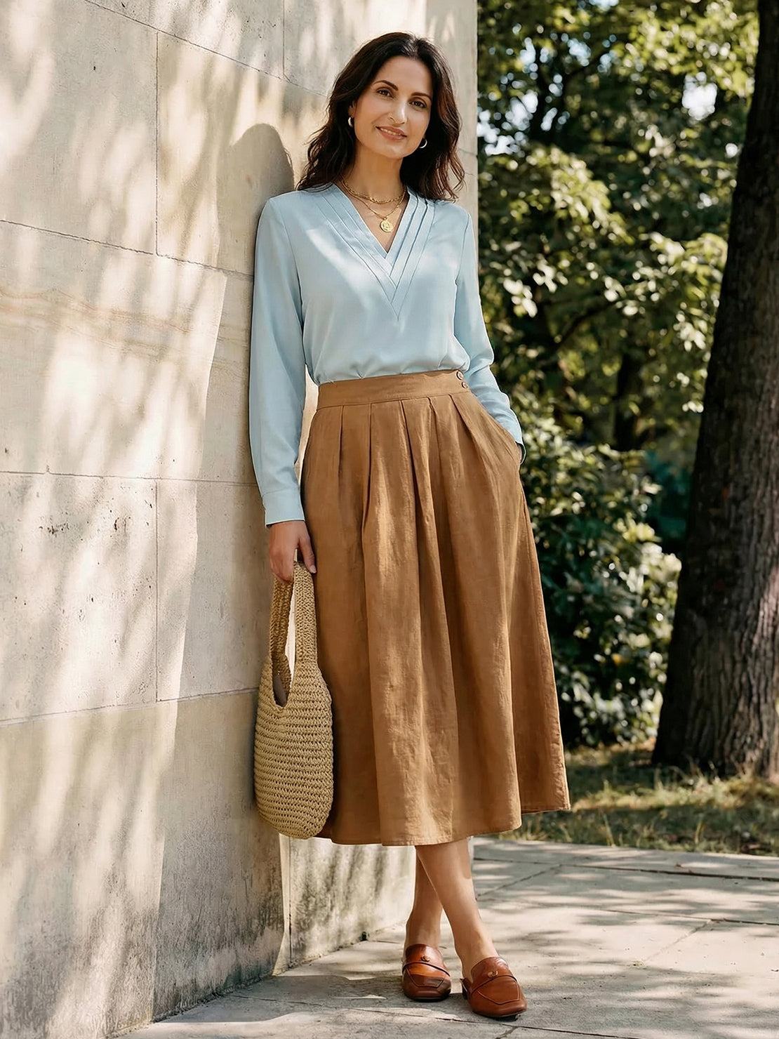 White pleated V-neck long-sleeve blouse with button cuffs and relaxed fit