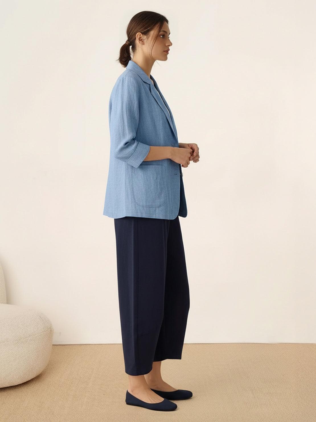 Cotton-linen blazer with notch lapels, two-button front, patch pockets, and natural textured fabric.