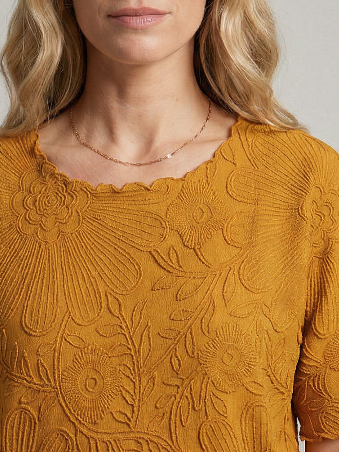 Lightweight floral jacquard pleated top with flutter sleeves and relaxed A-line silhouette