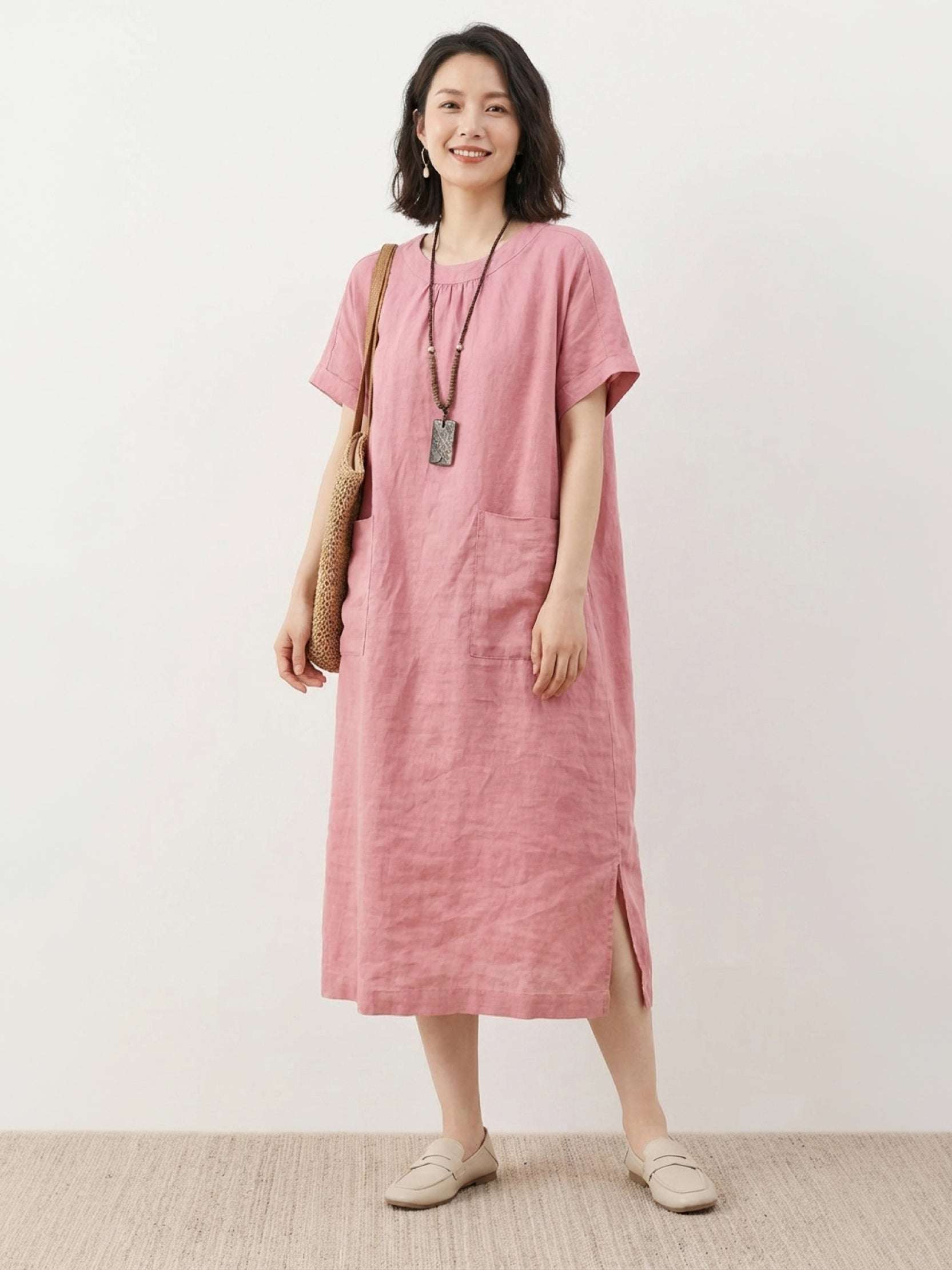 Woman wearing relaxed 100% linen pocket midi dress with short sleeves and side slits
