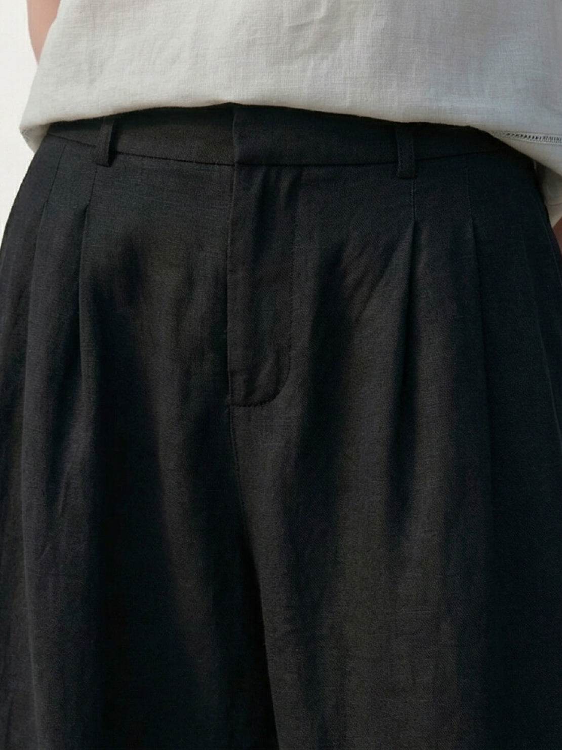 White Tencel-Linen pleated wide-leg pants with hook-and-zipper waist closure and floor-skimming silhouette