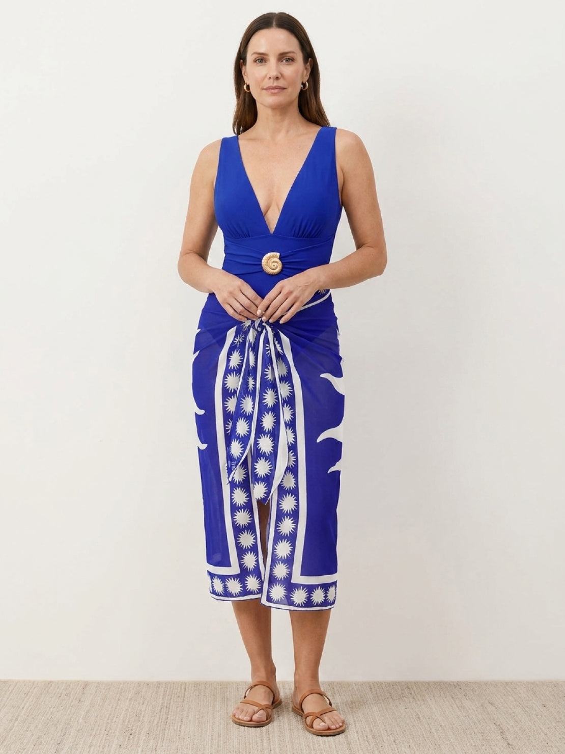 Deep-V swimsuit with ruched bodysuit and sheer celestial print sarong wrap