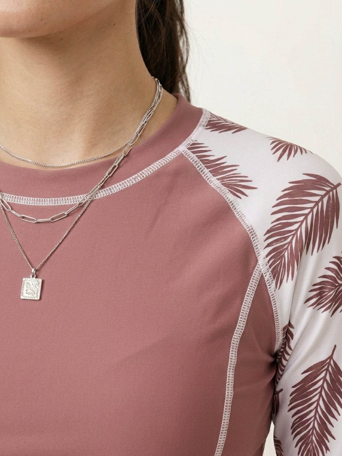 Long-sleeve UV rash guard set with tropical print sleeves and matching swim shorts for sun protection and sporty style