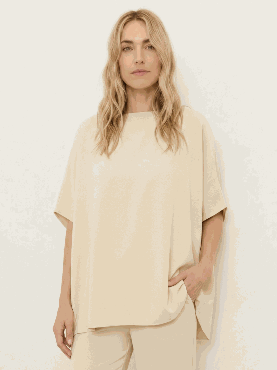 Woman wearing cotton-blend capelet top with batwing sleeves and wide-leg pants lounge set