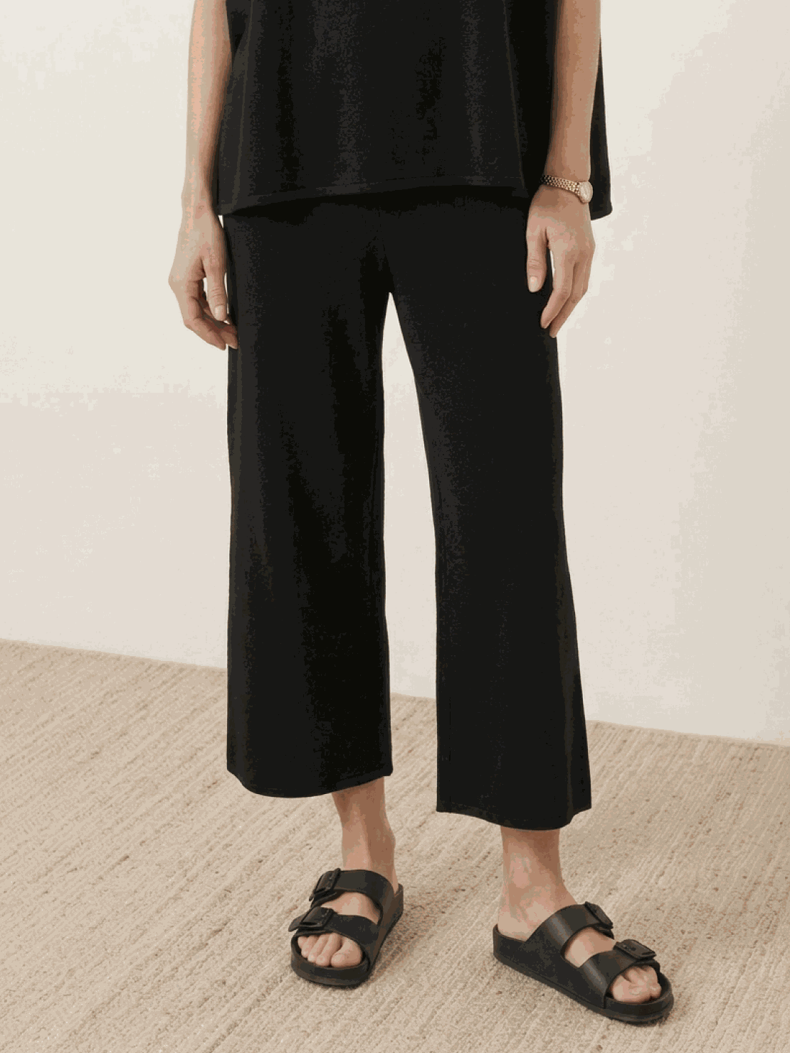 Woman wearing a cotton-blend capelet top with batwing sleeves and wide-leg pants lounge set in neutral tones