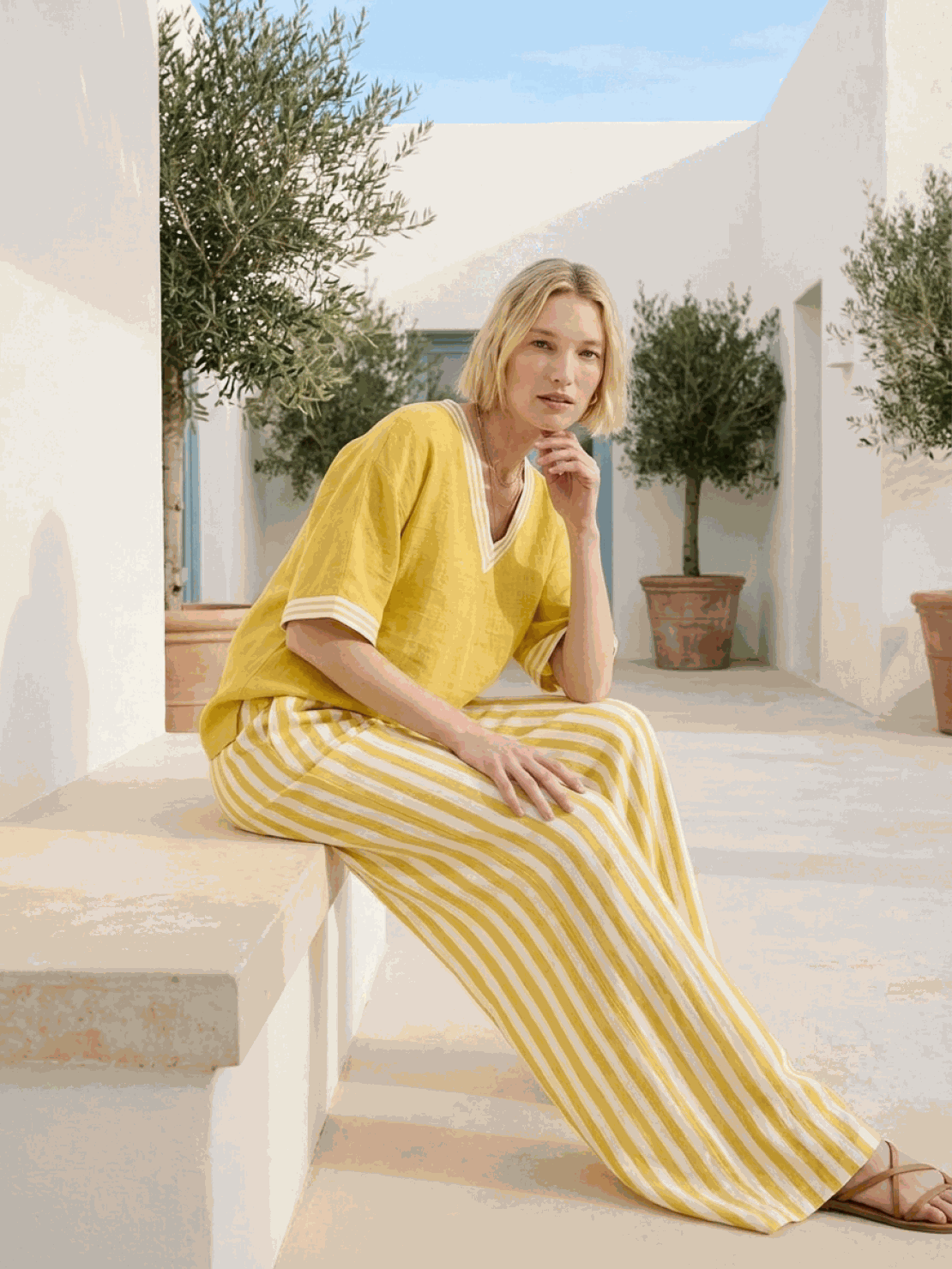 Woman wearing striped wide-leg co-ord set with oversized top and palazzo pants in multiple colors