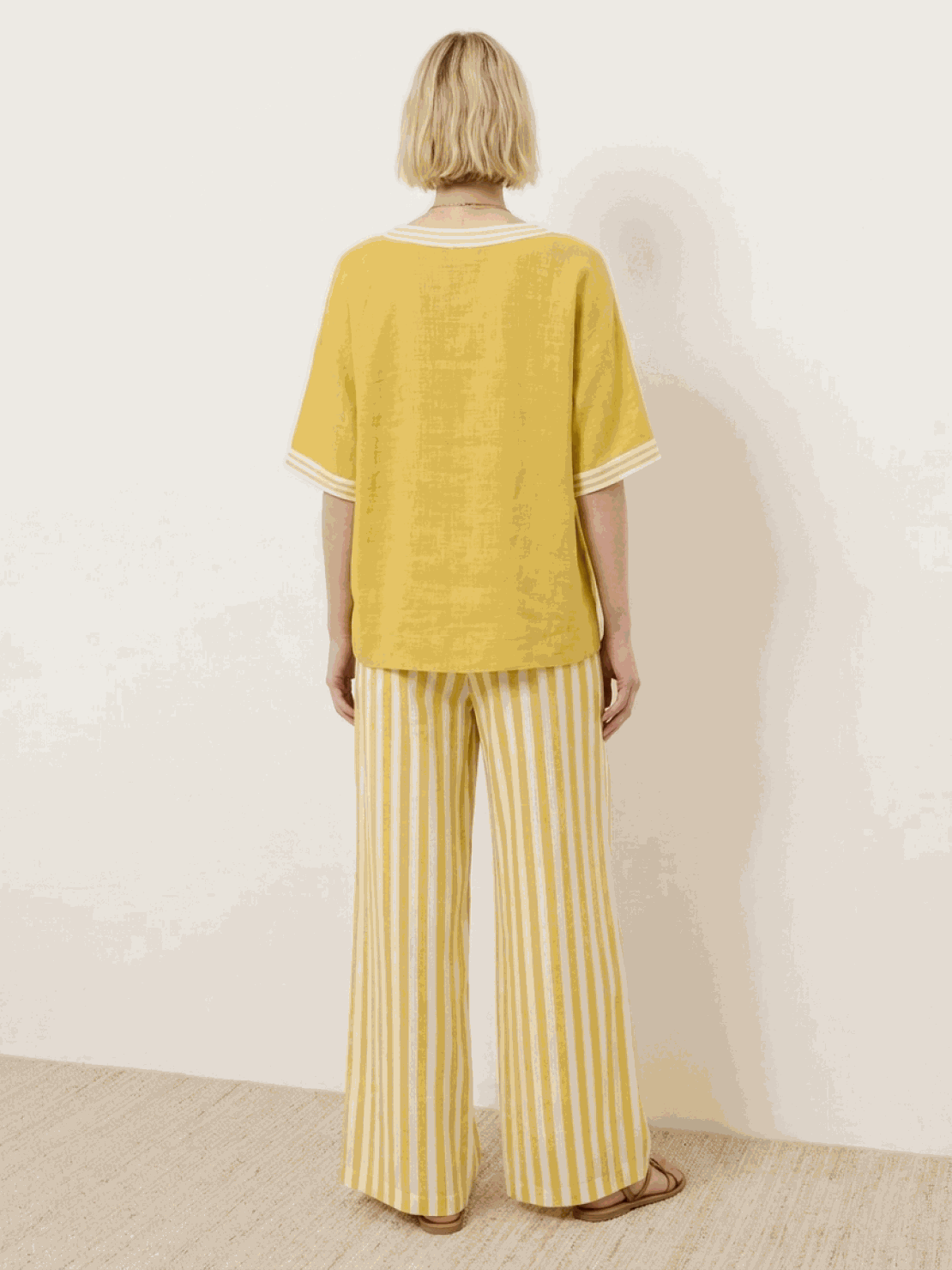 Woman wearing striped wide-leg co-ord set with oversized top and palazzo pants in multiple colors