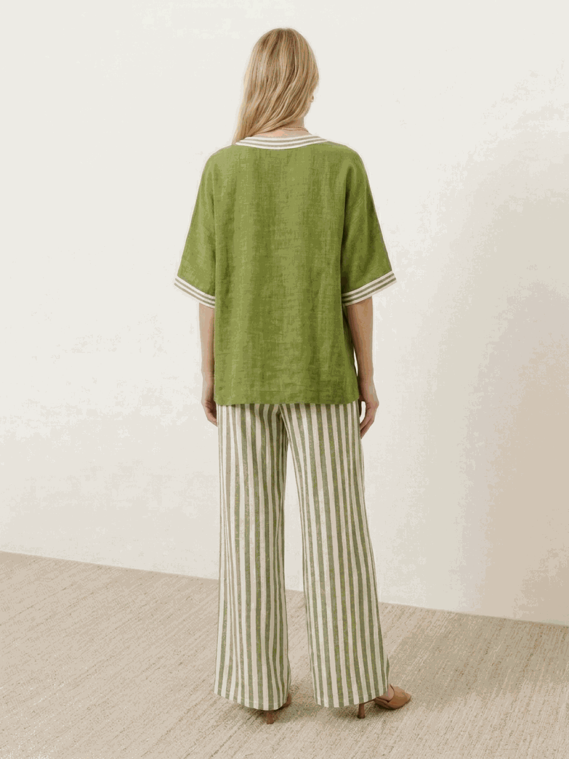 Woman wearing striped wide-leg co-ord set with oversized top and palazzo pants in multiple colors