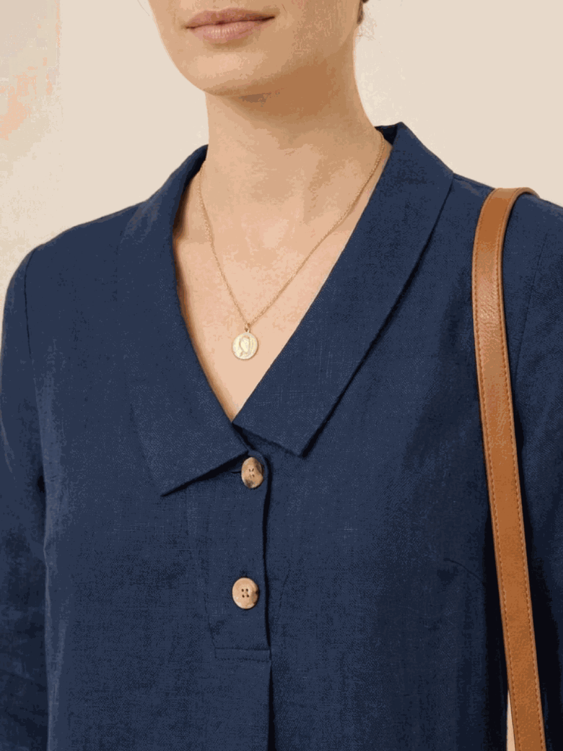 Woman wearing navy linen-look midi dress with 3/4 sleeves and side pockets