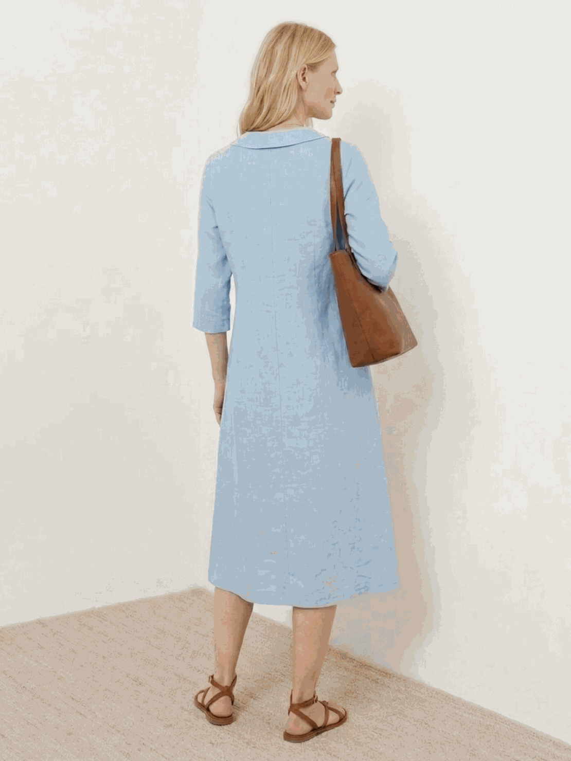 Woman wearing relaxed fit linen-look midi dress with blazer neckline and button detail