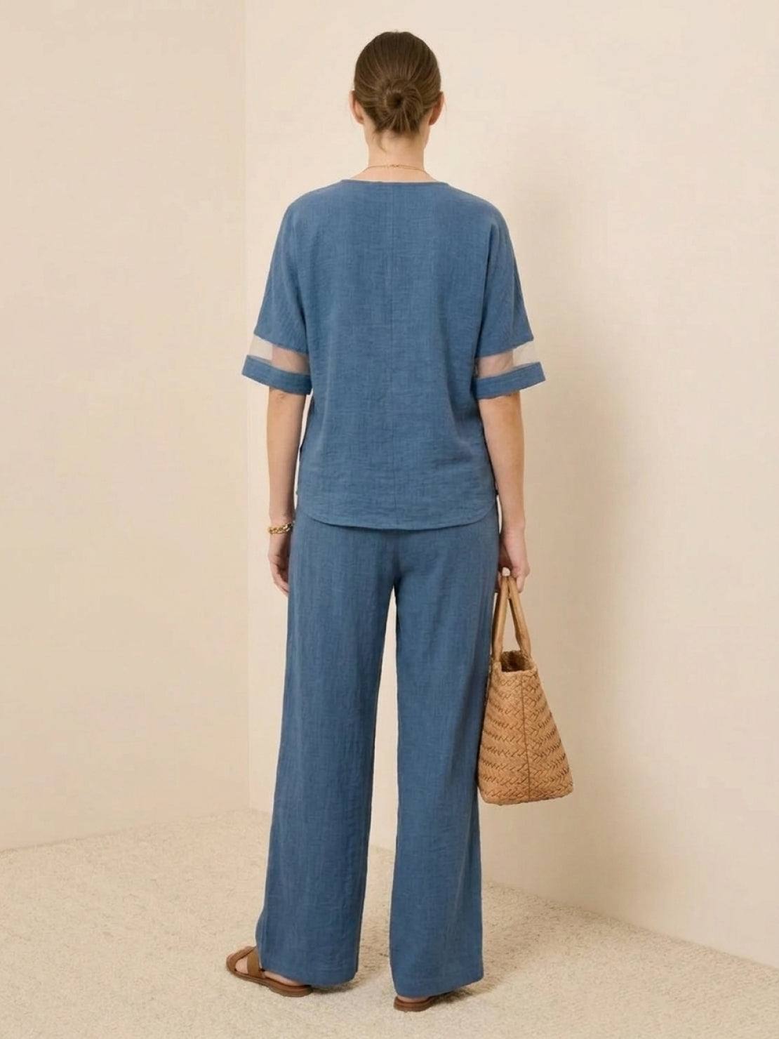 Mature woman wearing lightweight linen top with V-neck and button detail