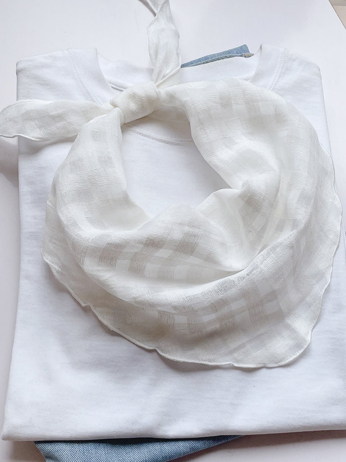 Lightweight 100% linen neck scarf with checkered pattern and natural rolled edges for versatile styling