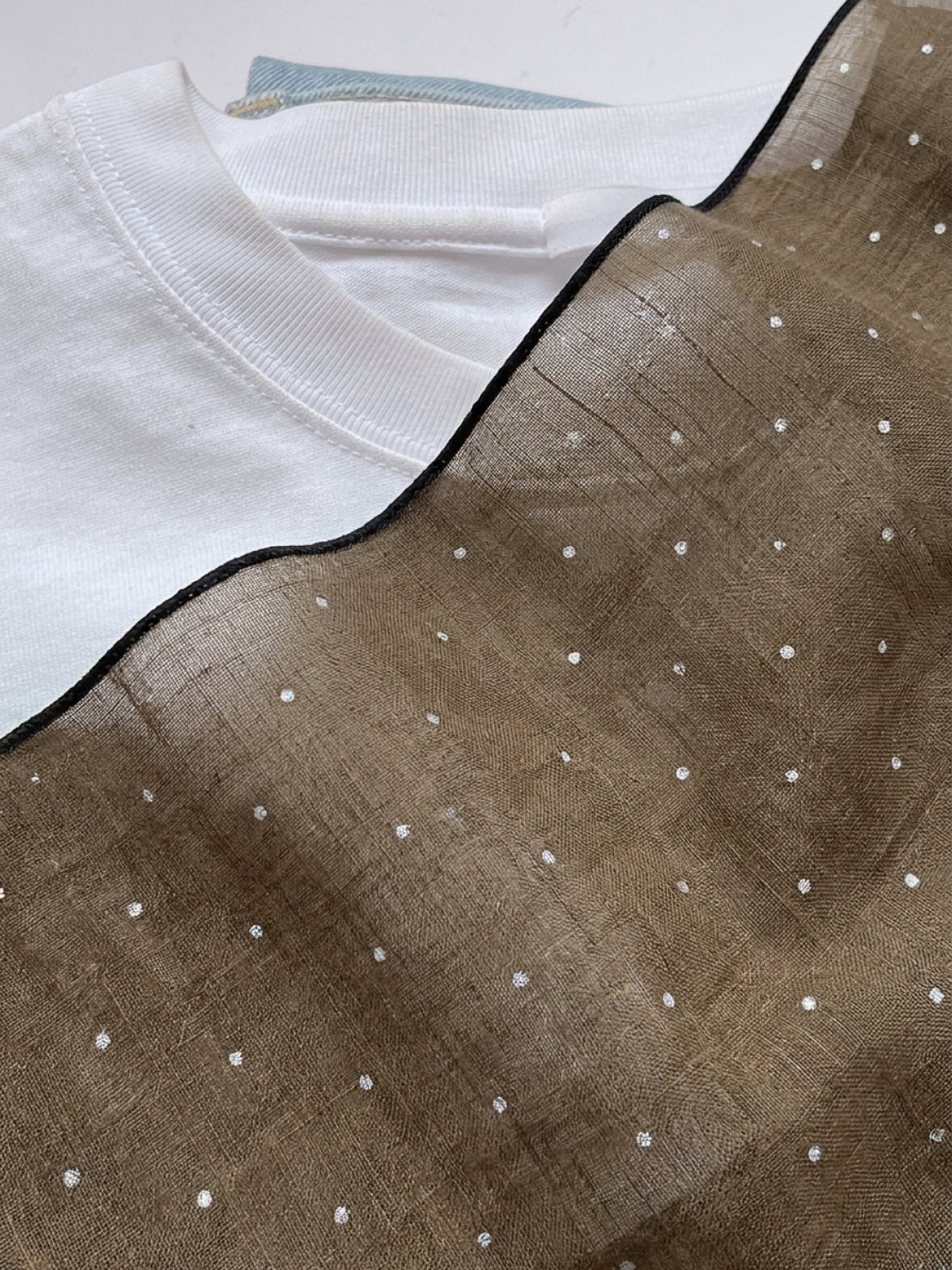 100% linen neck scarf with lightweight checkered linen fabric, versatile styling options, and natural rolled edges