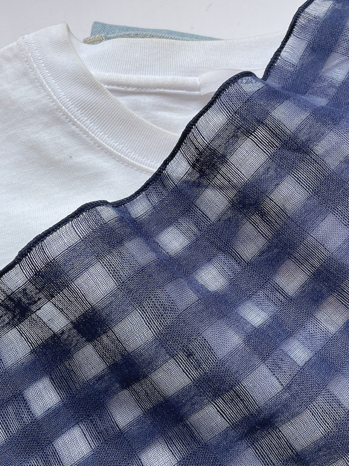 Lightweight 100% linen neck scarf with timeless checkered pattern and natural rolled edges