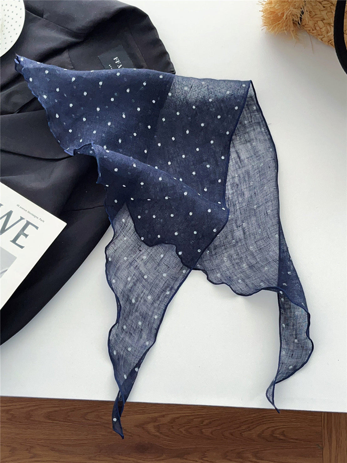 Lightweight 100% linen neck scarf with timeless checkered pattern and natural rolled edges, styled around neck.