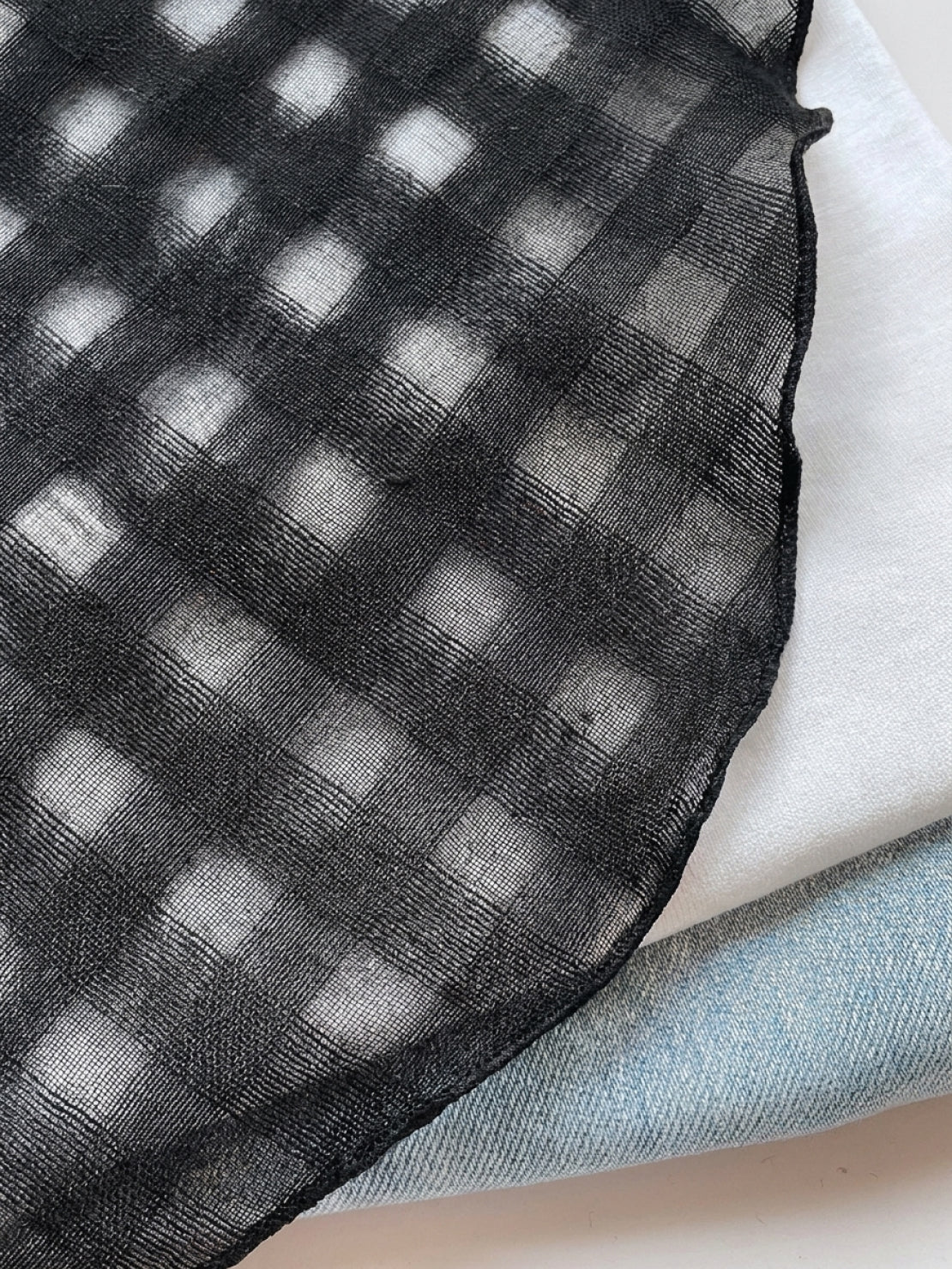 Lightweight 100% linen neck scarf with timeless checkered pattern and natural rolled edges