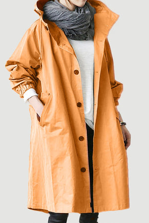 Water-resistant oversized hooded windbreaker rain jacket in orange with button closure and elastic cuffs