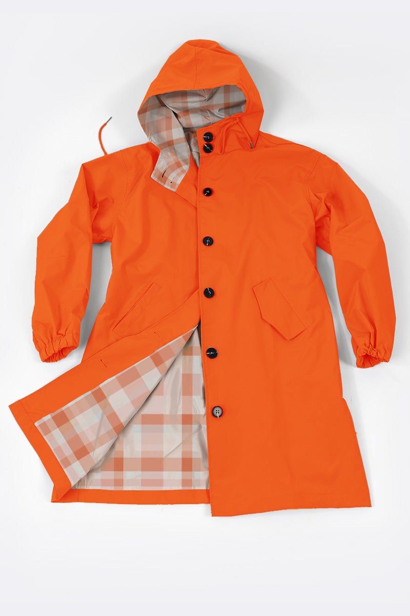 Orange water resistant oversized windbreaker with hood and plaid interior lining
