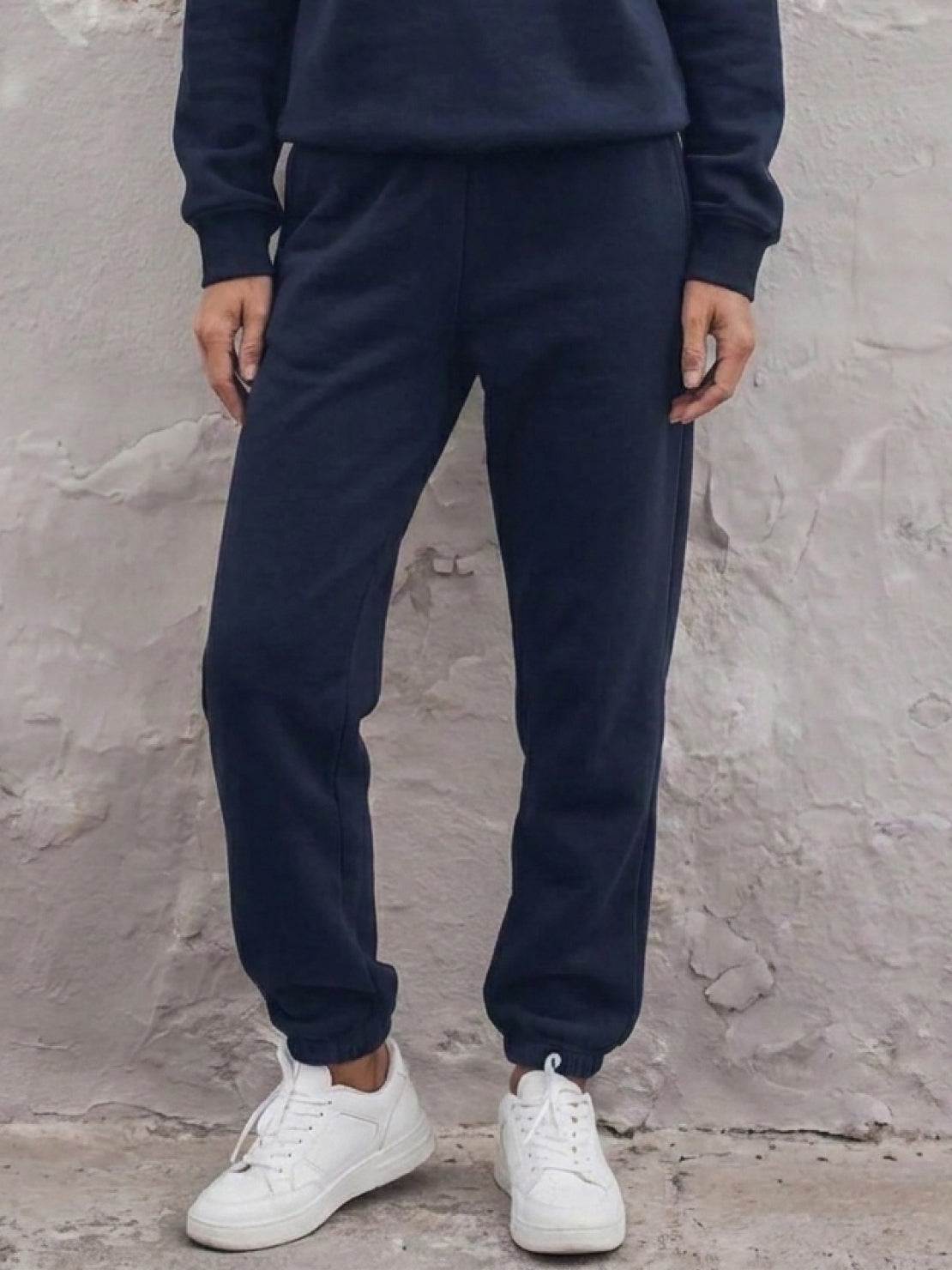 cotton-blended two-piece tracksuit with zip-front top and straight-leg pants on white background