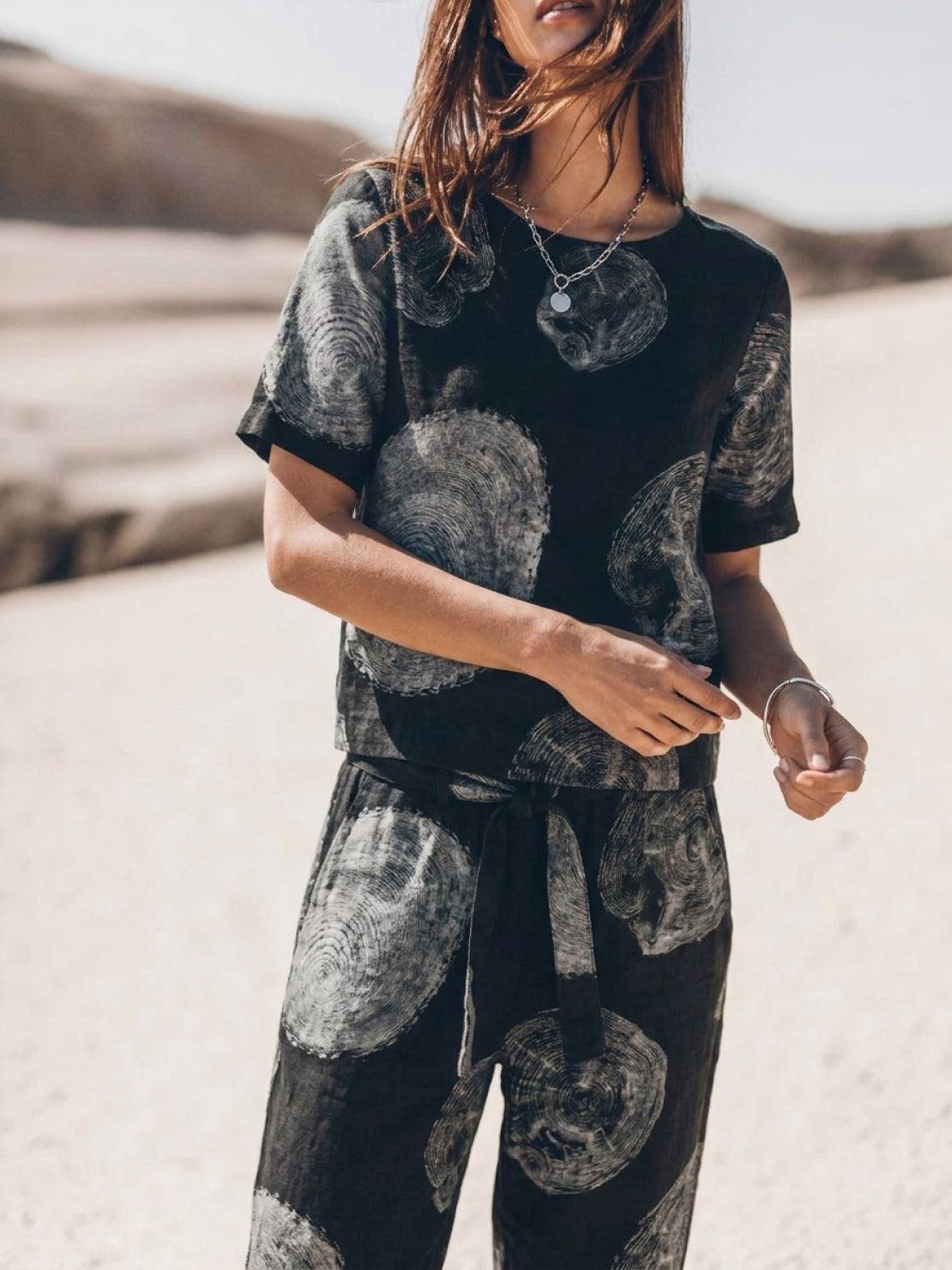 Woman wearing a relaxed monochrome cotton linen set with short sleeves and straight-leg pants