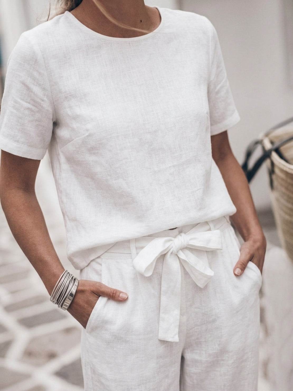 woman wearing 100% cotton linen set with relaxed short-sleeve top and straight-leg pants in monochrome color