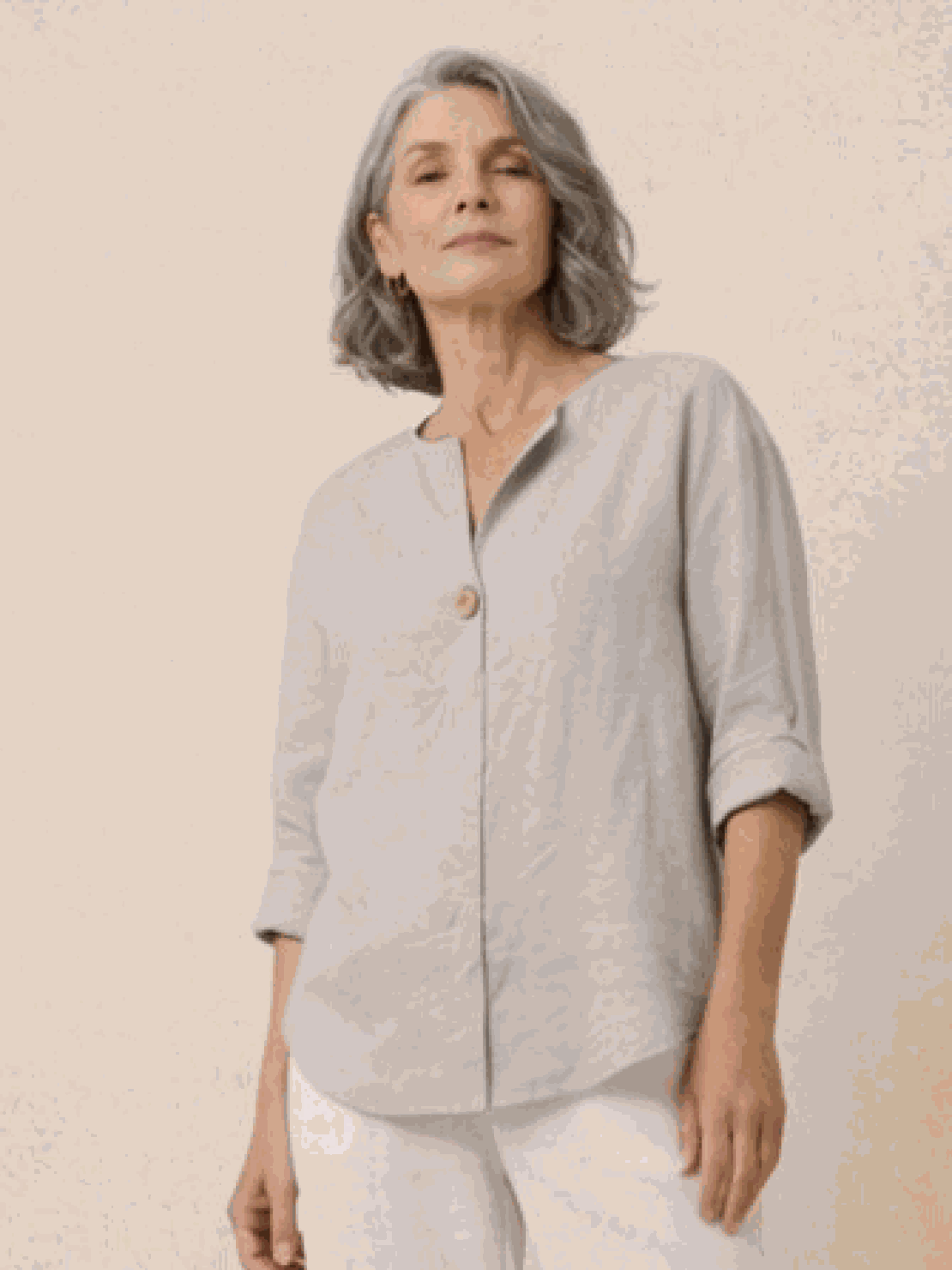 White pure linen age-defying shirt with button detail on hanger