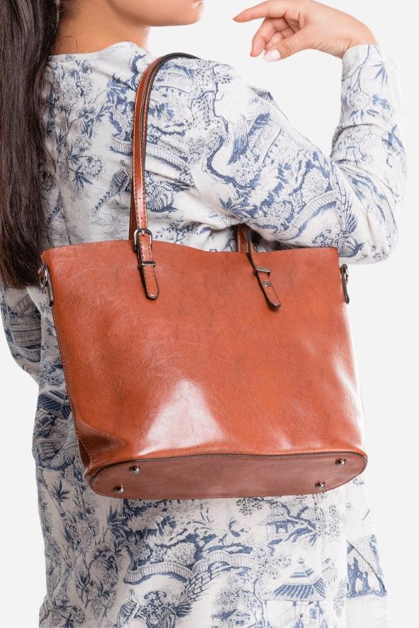 Brown PU leather multi strap tote shopper bag worn on shoulder with buckle details and spacious interior